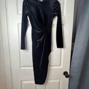 A black one legged velvet dress.